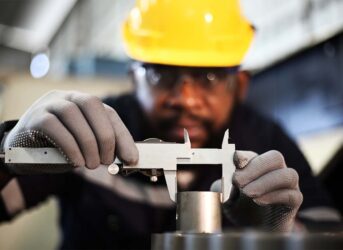 engineer checking auto parts in factory
